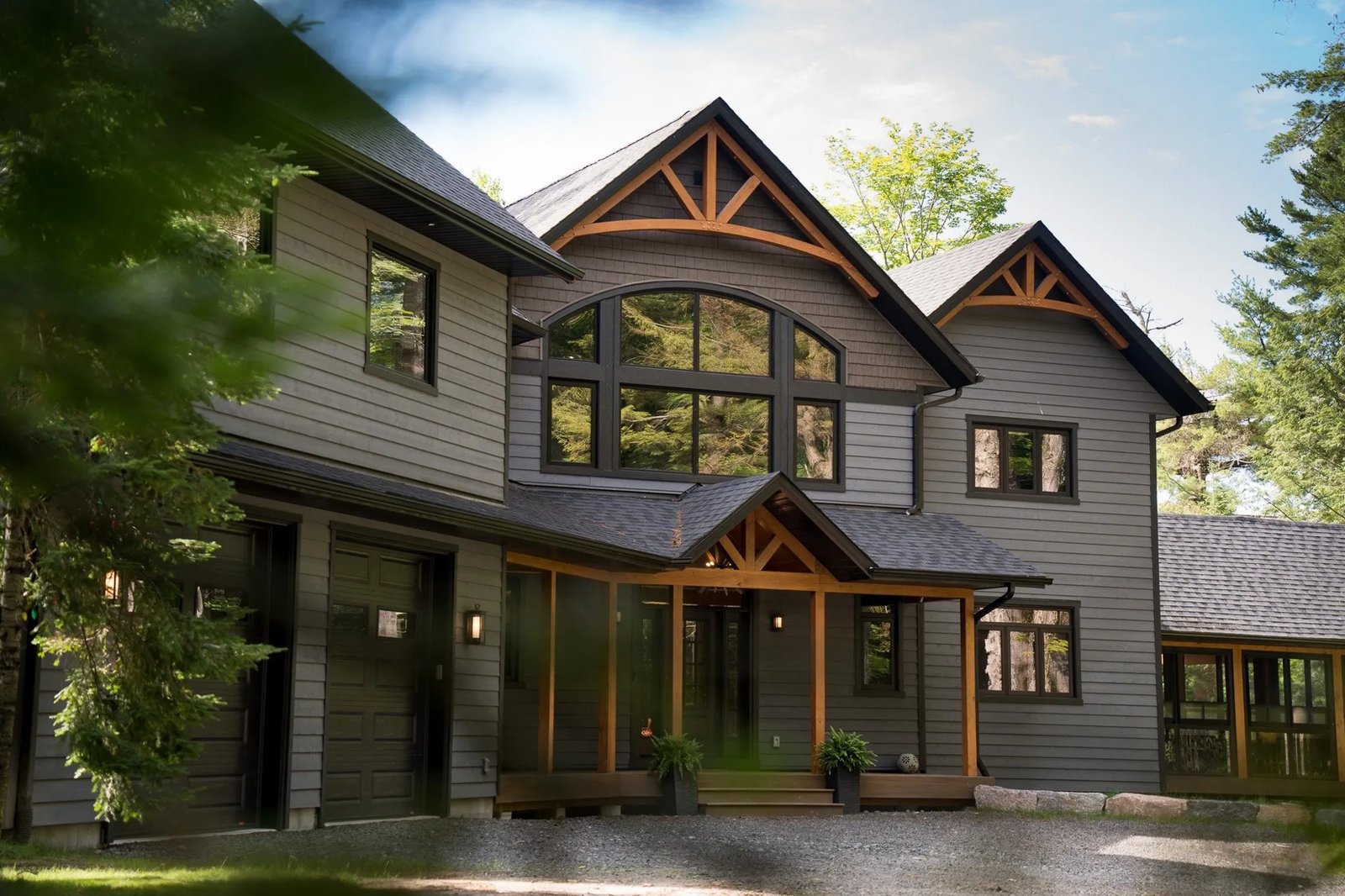 Architectural home with stone, timber and expansive windows